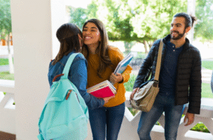 “Students in Spain greeting with two kisses at university campus."