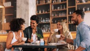 Students who became friends through Spanish classes at LAE Madrid, drinking coffee together and connecting outside the classroom.