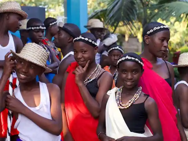 Group of children wearing traditional African attire and jewelry during a cultural event supported by LAE Madrid and Kelele África
