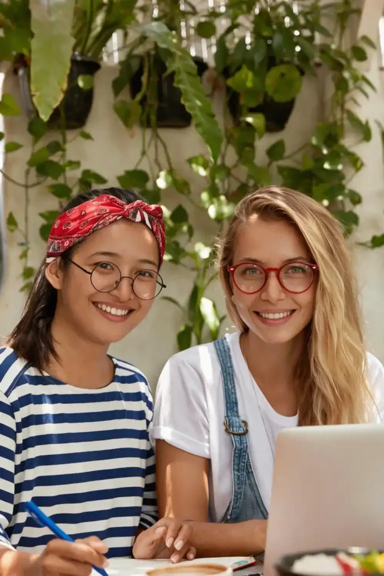 Student and native teacher smiling together during individual Spanish classes using a laptop.