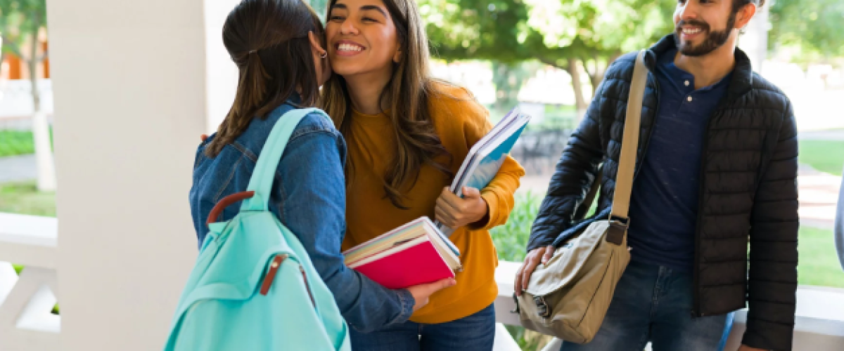 “Students in Spain greeting with two kisses at university campus."