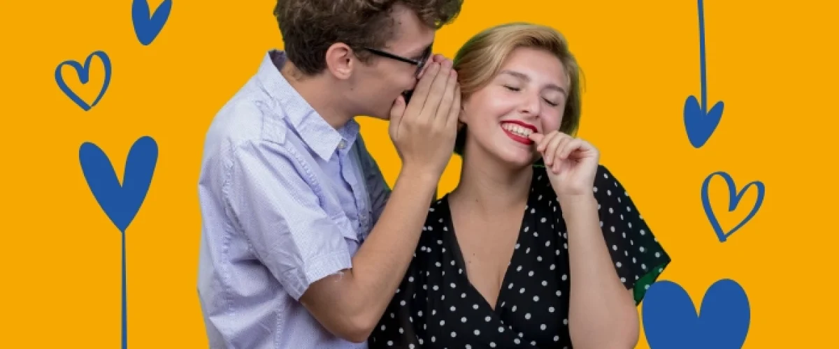 A man whispering into the ear of a laughing woman, illustrating the warmth and connection of the Spanish language in Madrid.