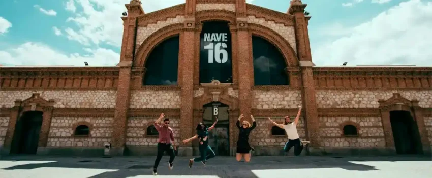 Students jumping in front of Nave 16 at Matadero Madrid, a cultural and arts space in the city