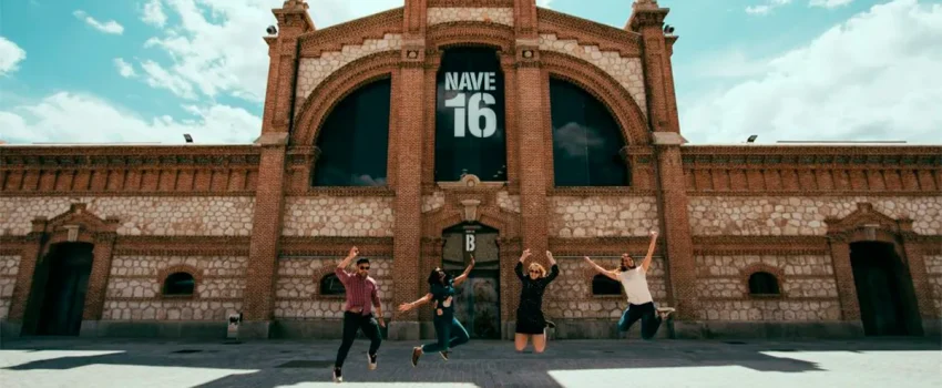 Cultural Experiences with LAE Madrid | Visit to Matadero Madrid Students jumping in front of Nave 16 at Matadero Madrid, a cultural and arts space in the city