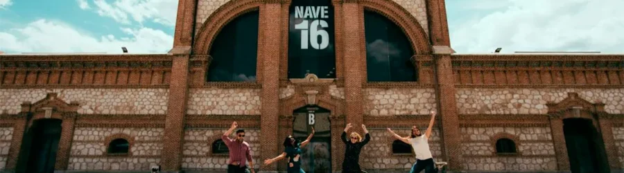 Students jumping in front of Nave 16 at Matadero Madrid, a cultural and arts space in the city